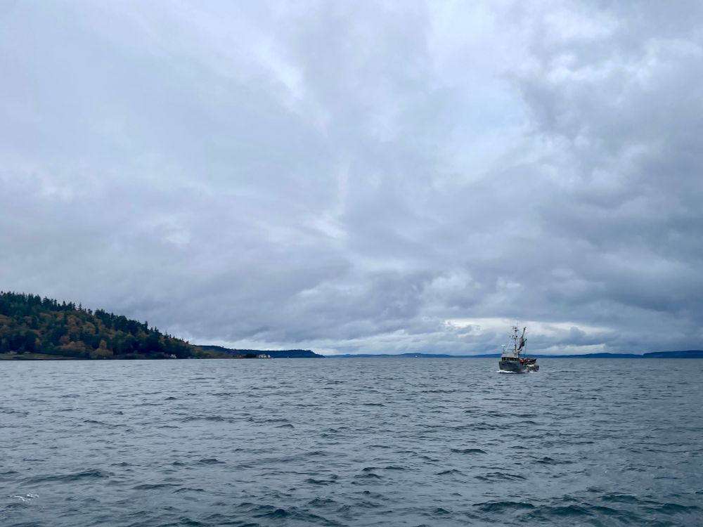A boat sailing under cloudy skies on Puget Sound near Kingston WA