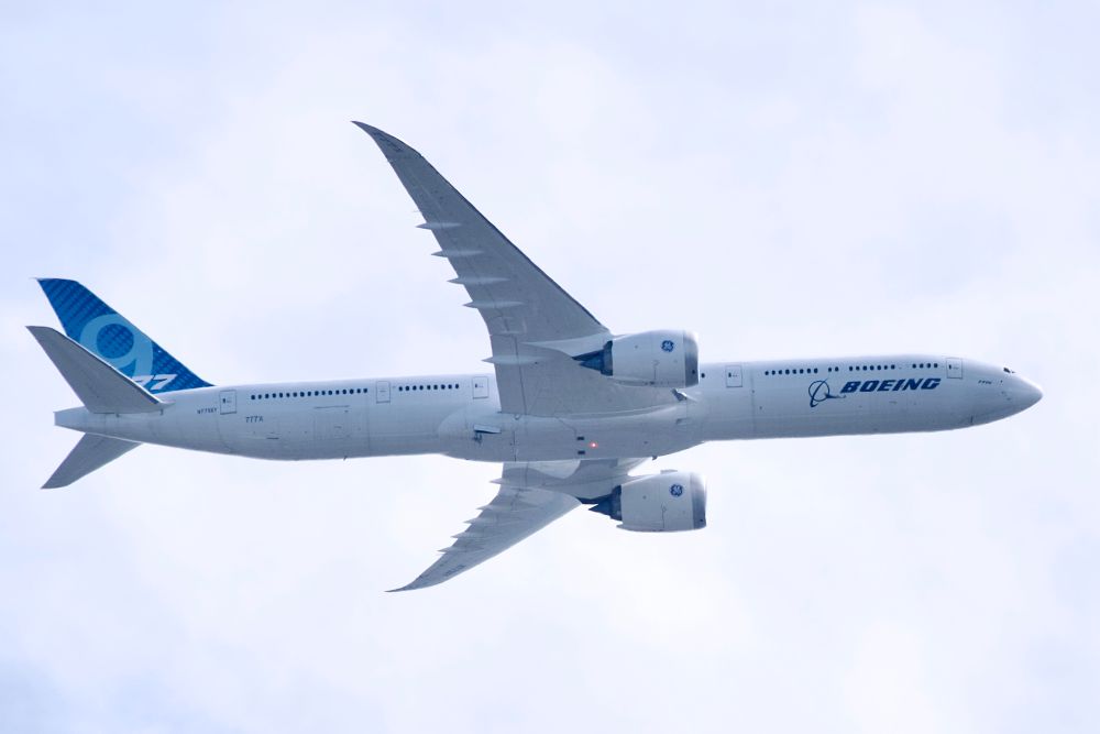 A photo of Boeing 777X aircraft N779XY in flight with ram air turbine (RAT) deployed. 