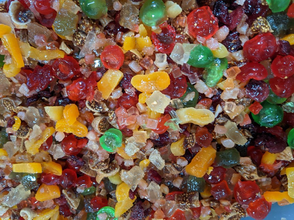 Bright colors of dried and candied fruits all mixed together.