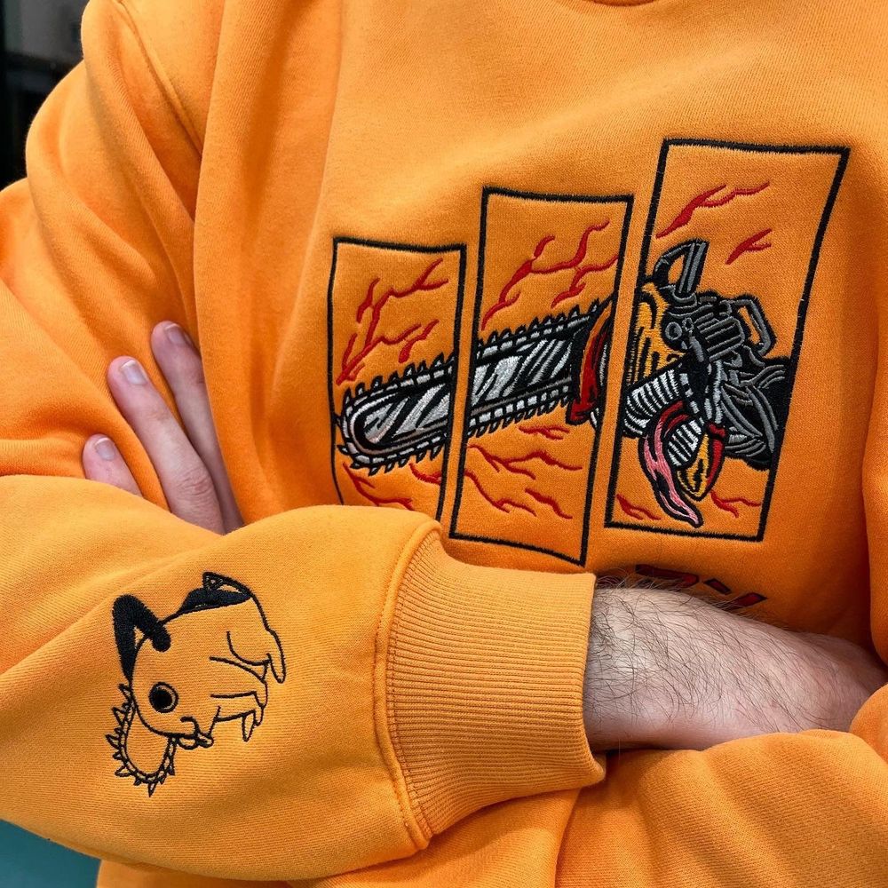 Model wearing this sick-ass orange Chainsaw Man embroidered sweatshirt featuring Denji and Pochita.