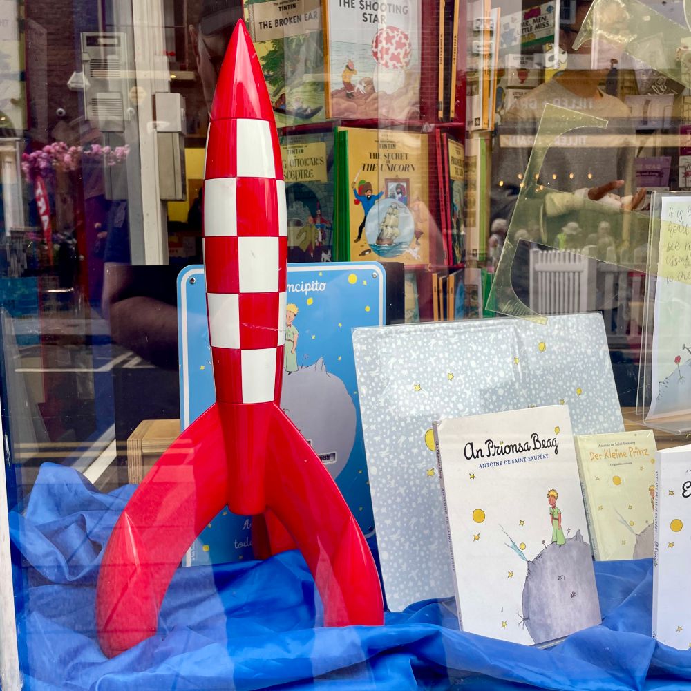 A foot high model version of the Red rocket from TinTin comic on display in a book shop window 