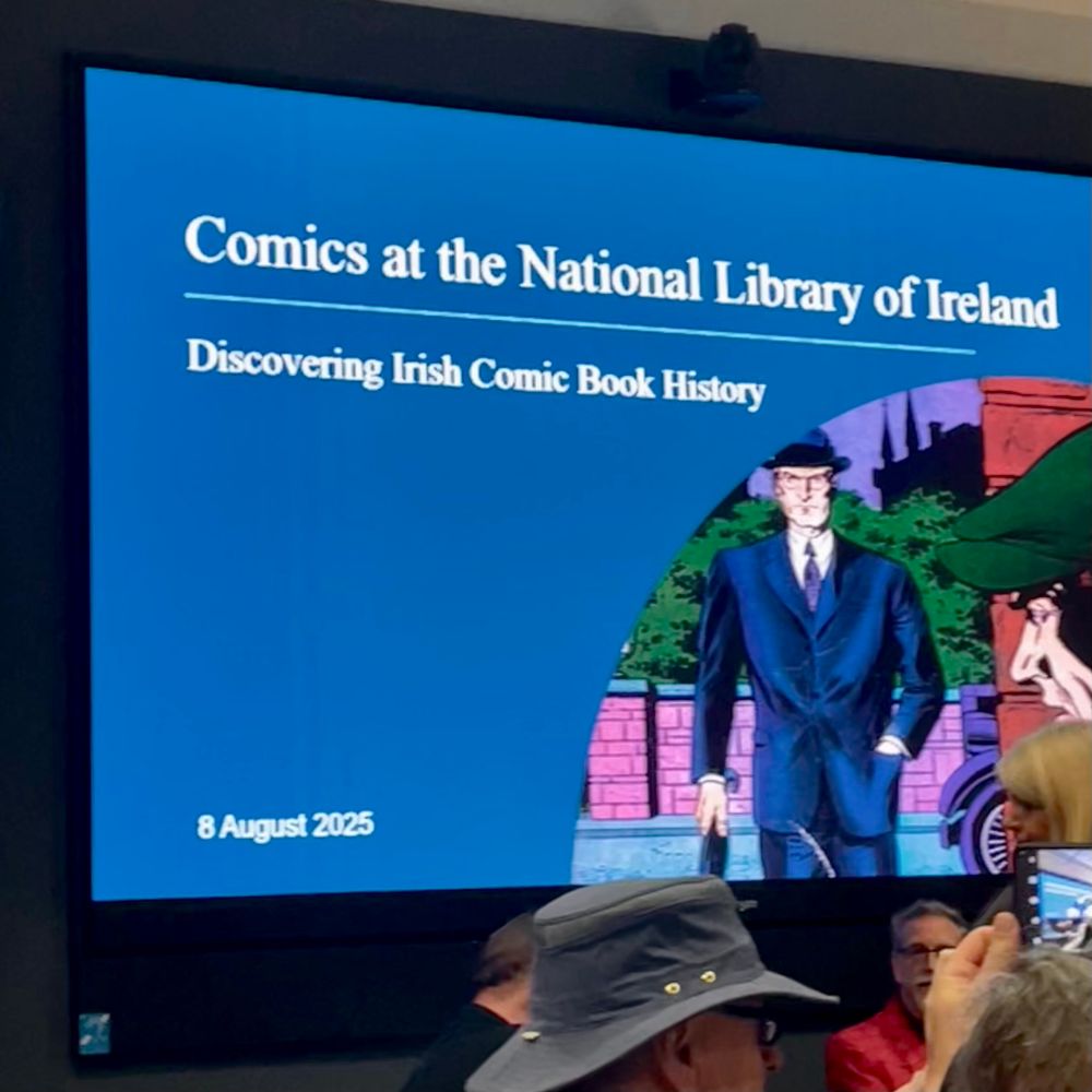 A slide with a Clark Kent type comic character in a suit, hat, tie and spectacles. Text: Comics at the National Library of Ireland Discovering Irish Comic Book History  8 August 2025
