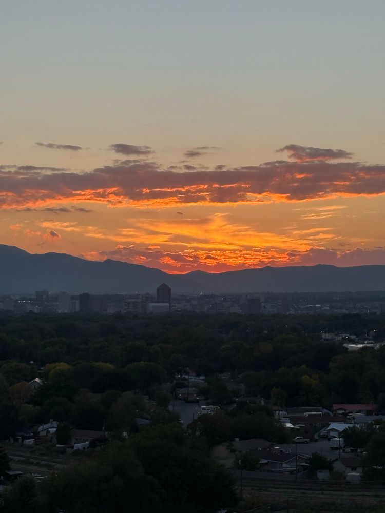 Sunrise over the Sandia mountains and downtown Albuquerque skyline