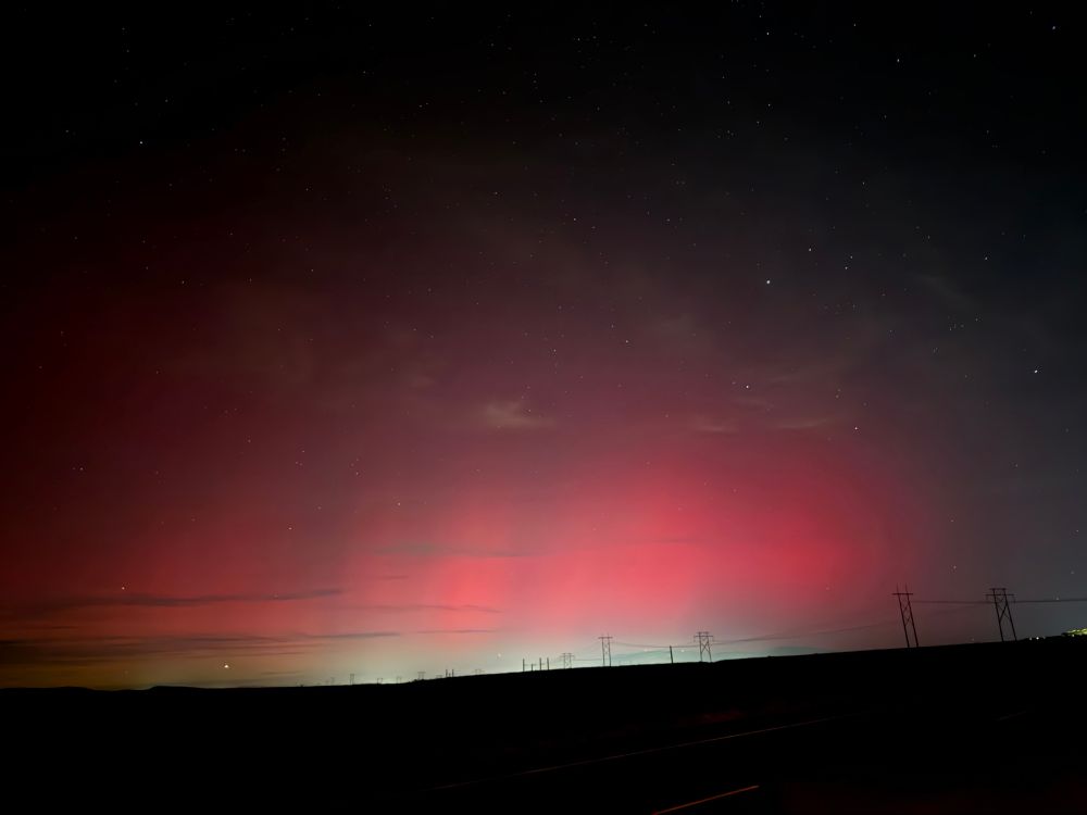 Night sky with stars and a red tint from the aurora borealis