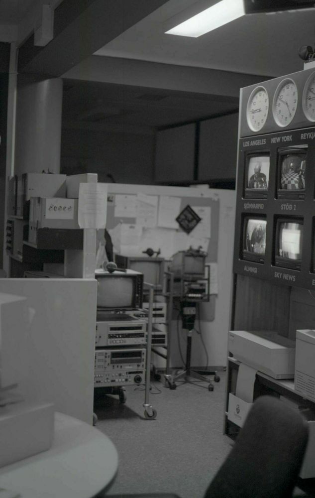 A photo of the old TV newsroom. You can see the desks and the wall of screens showing both the current broadcast and other channels.