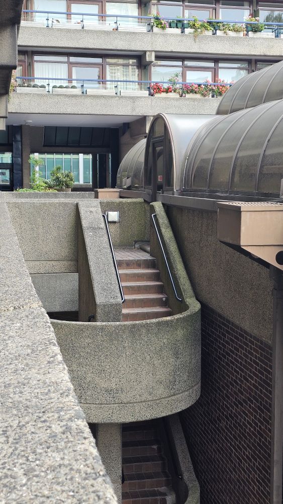 A warren of concrete staircases, apartment balconies and greenhouses.