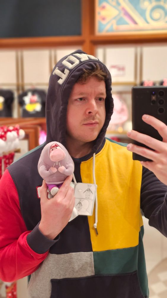 A large, pink, embarrassed character in a hoodie. Also an Inside Out plush.