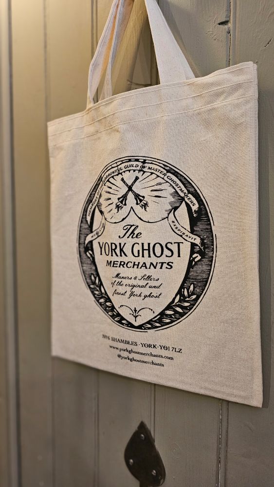 A tote bag with The York Ghost Merchants logo.