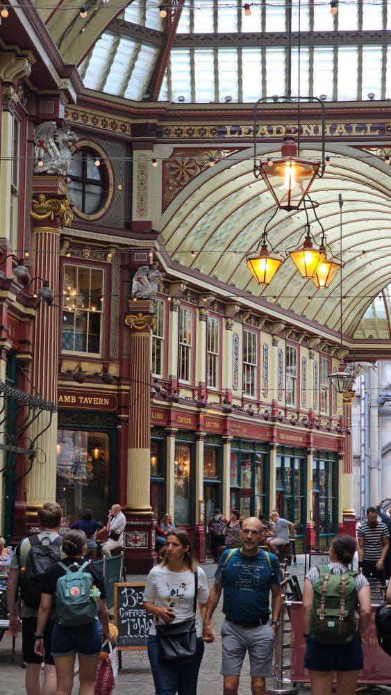 The interior of the Victorian arcade with arched glass roofs, painted columns and glass lamps.