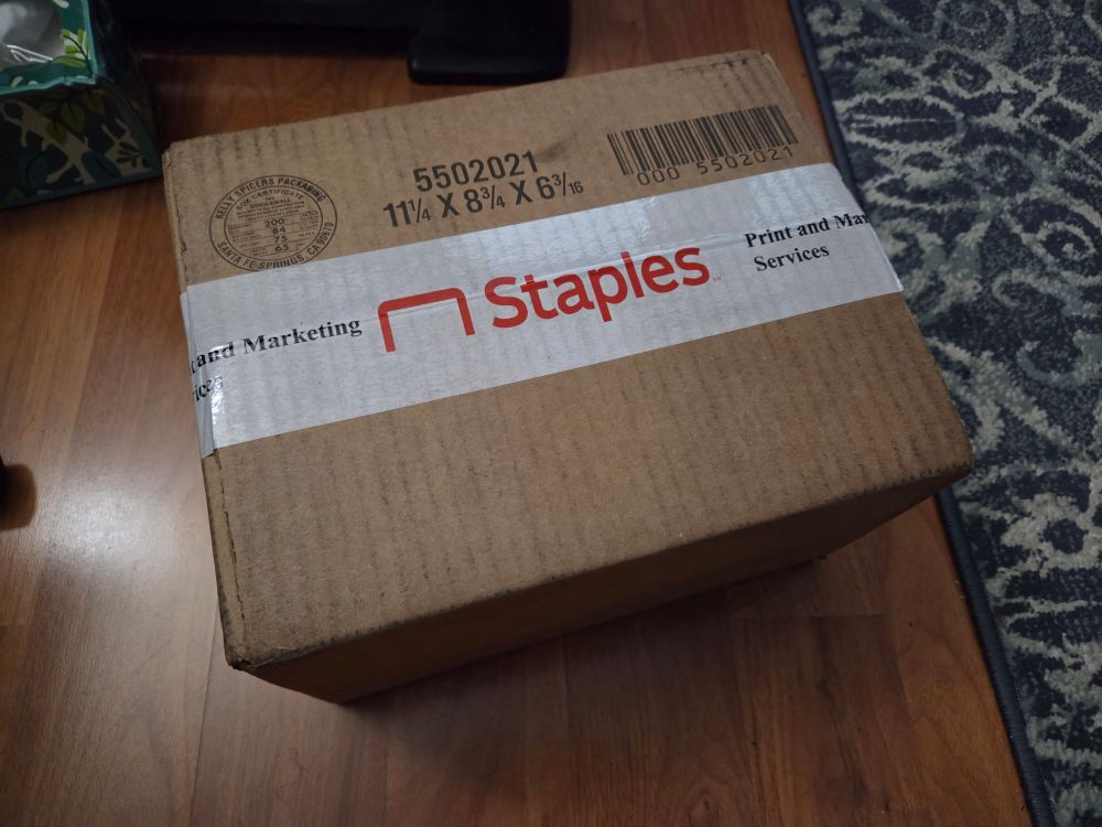 A photo of a cardboard box with the staples logo on the tape. 