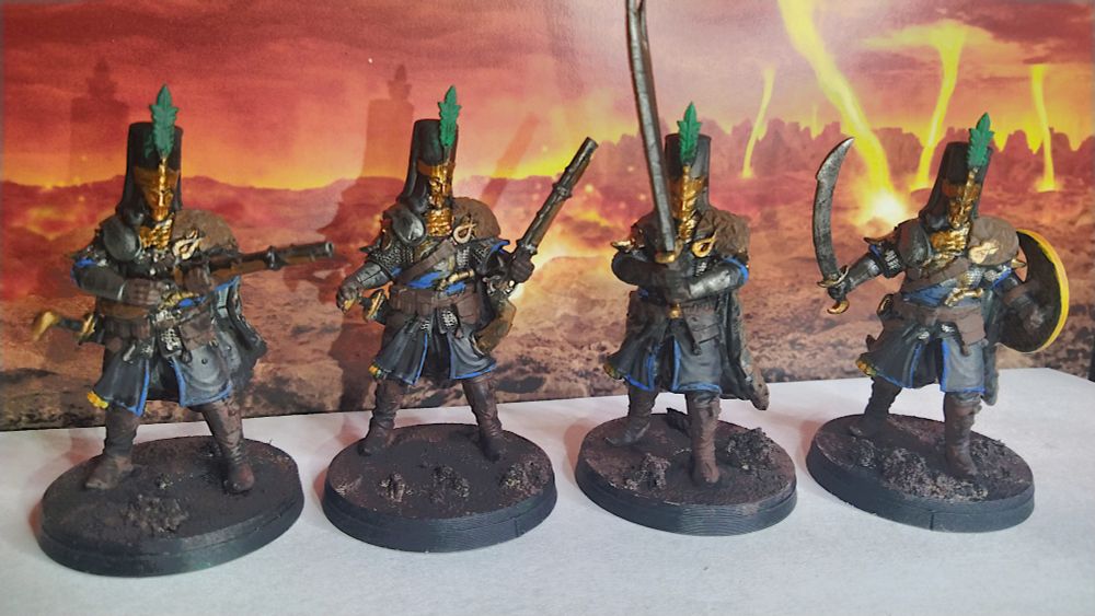 Trench Crusade Janissaries wearing gold armour and black overcoats with blue trim.