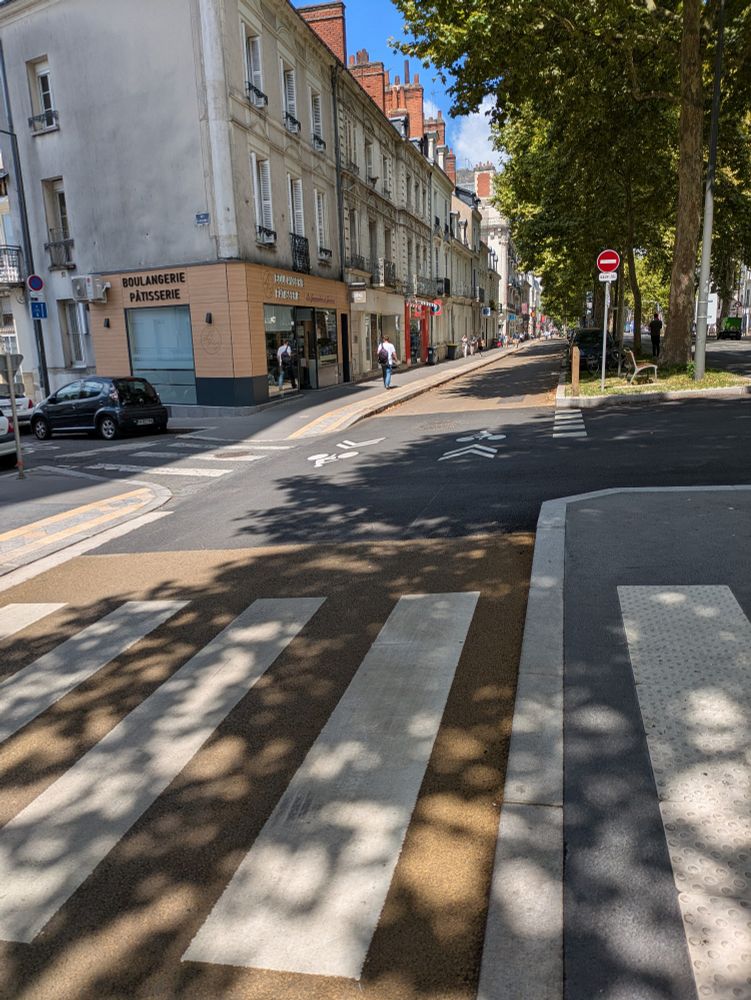 Two way road for cycling with limited one-way entry for motor vehicles.