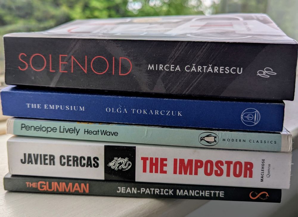 A book pile: Solenoid by Mircea Cartarescu, The Empusium by Olga Tokarczuk, Heat Wave by Penelope Lively, The Impostor by Javier Cercas and The Gunman by Jean-Patrick Manchette. 