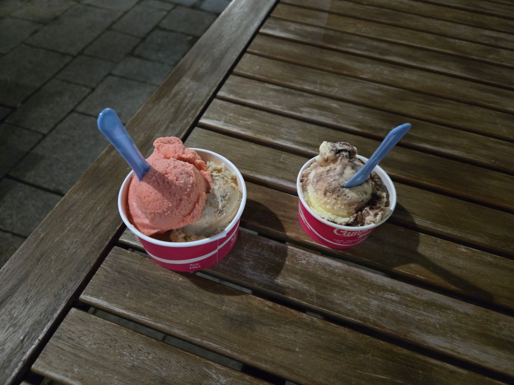 Two cups of ice cream, on a wooden table