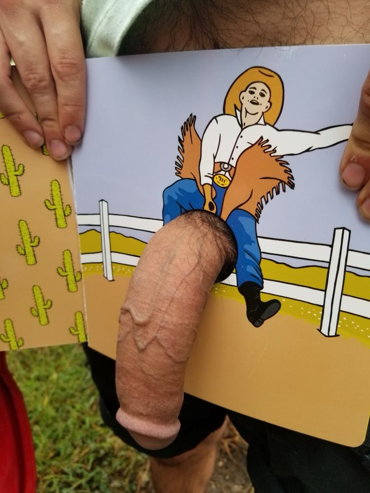 semi-erect cock going through boom with a penis shaped hole in it. on page is a cowboy riding my cock