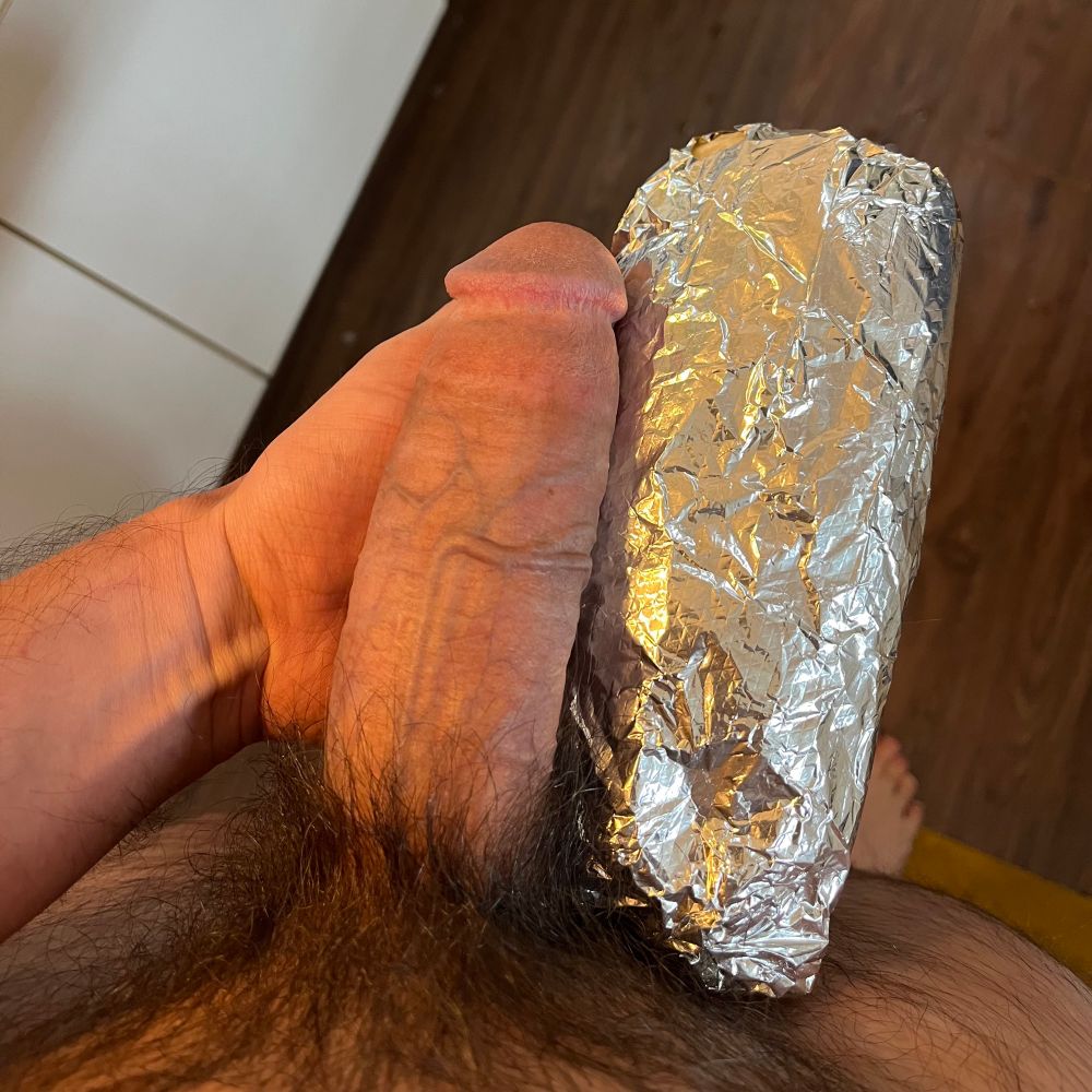 my cock erect next to a burrito wrapped in tin foil