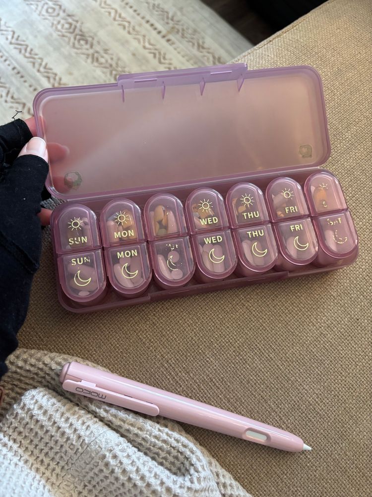 photo of a pink pill case before i put stickers on it, sole paint is scratched off and you can’t tell what day it is for 