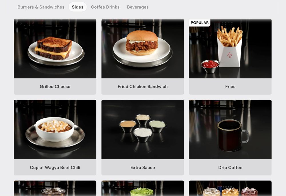 the "Sides" section of the Tesla Diner menu, which no longer features a $12 container of "Epic Bacon"