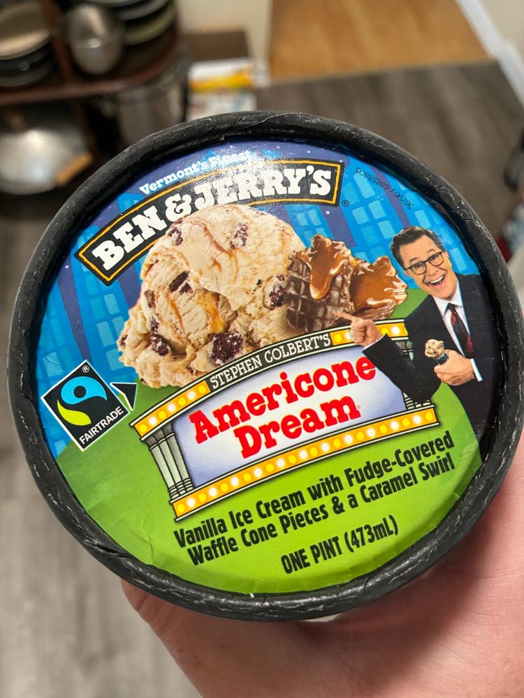pint of Ben & Jerry Stephen Colbert’s Americone Dream: vanilla ice cream with fudge-covered waffle cone pieces and a caramel swirl