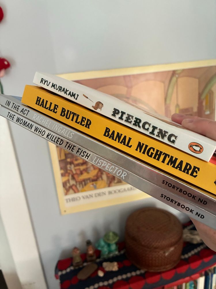stack of new books: Ryu Murakami, Piercing Halle Butler, Banal Nightmare Rachel Ingalls, In the Act Clarice Lispector, The Woman Who Killed the Fish 