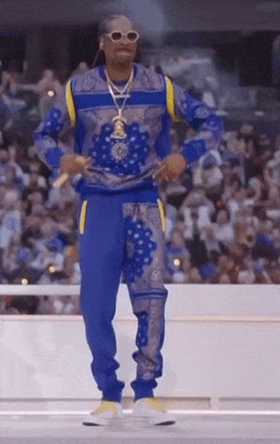 snoop dogg is wearing a blue and yellow outfit