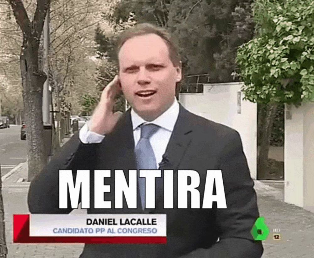 a man in a suit and tie is talking on a cell phone with a sign that says mentira on it