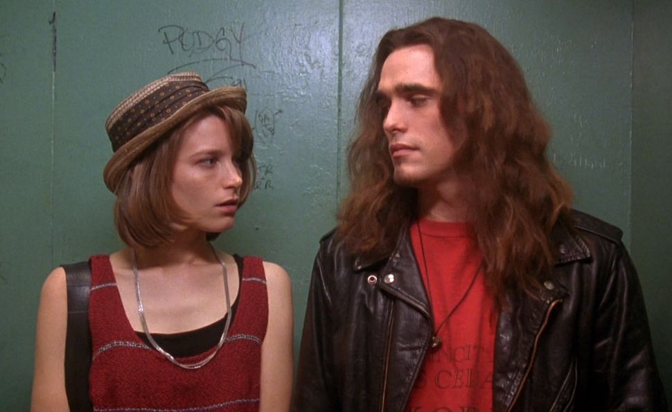 A man and woman look at each other in an elevator