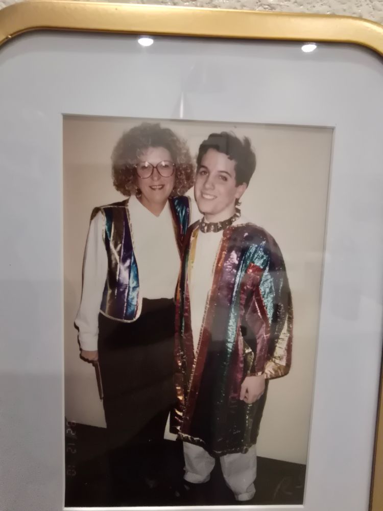 A Sally Jesse Raphael-type mom and her gay-ass son. Both in rainbow Joseph attire