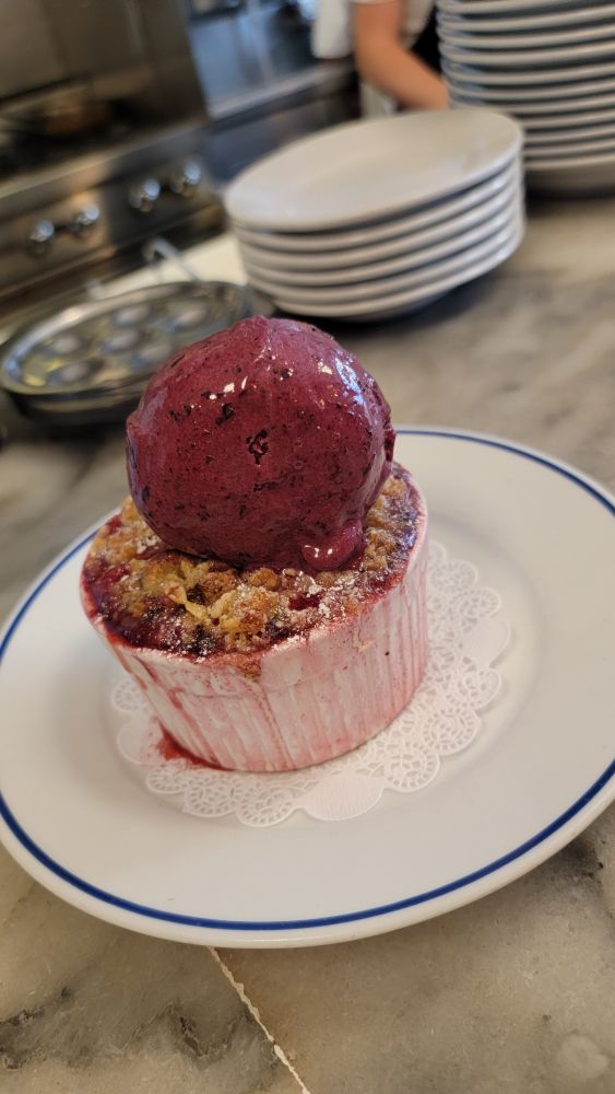 A ridiculously delicious berry crumble with scoop of blackberry ice cream at Petit Trois