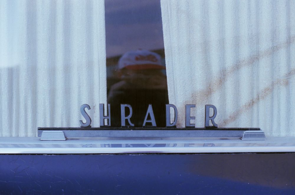 picture of a hearse window with a logo that says Shrader