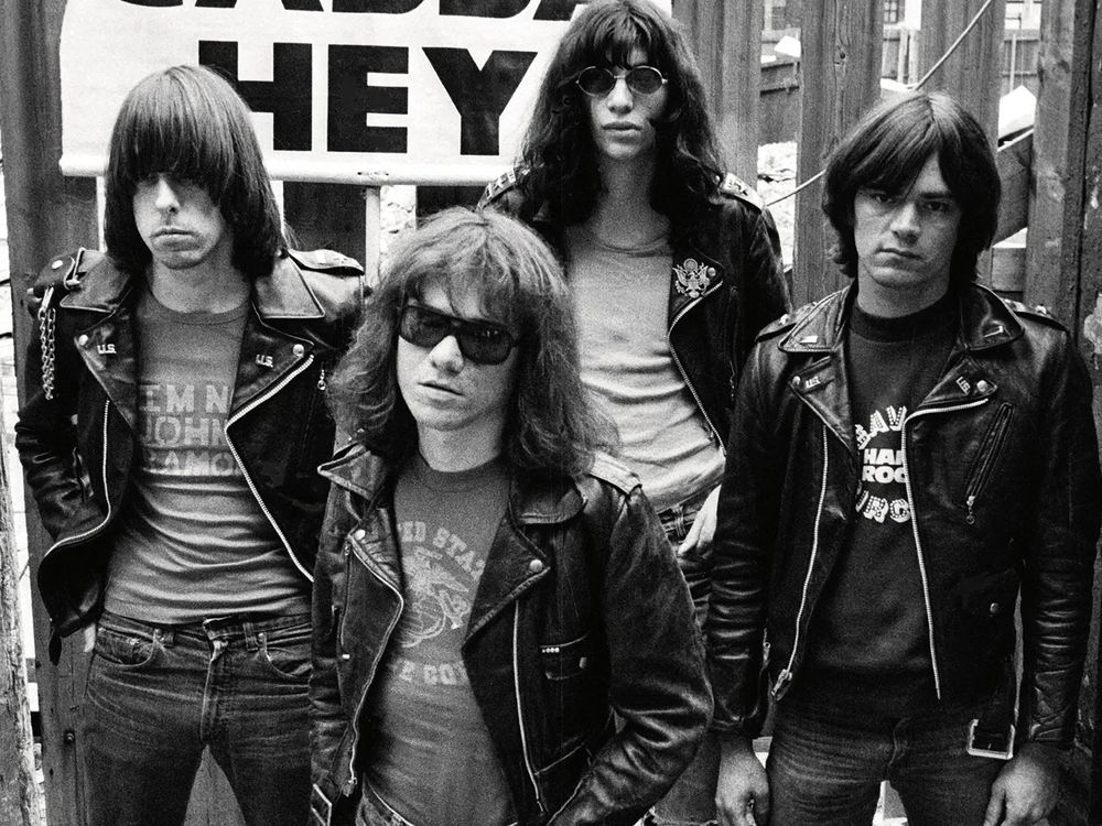 A photo of the punk rock band The Ramones, all decked out in leather jackets in front of a sign that reads GABBA GABBA HEY