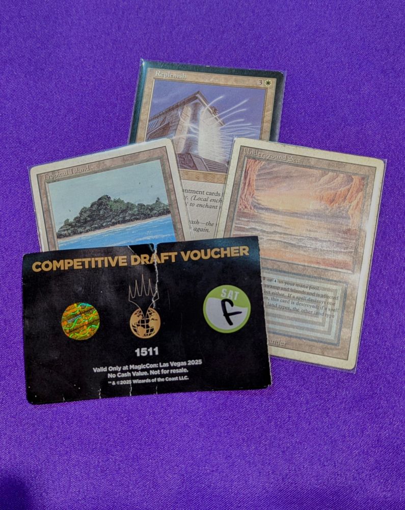 Three very rare Magic cards placed under the same entry ticket: Underground Sea, Tropical Island, and Replenish
