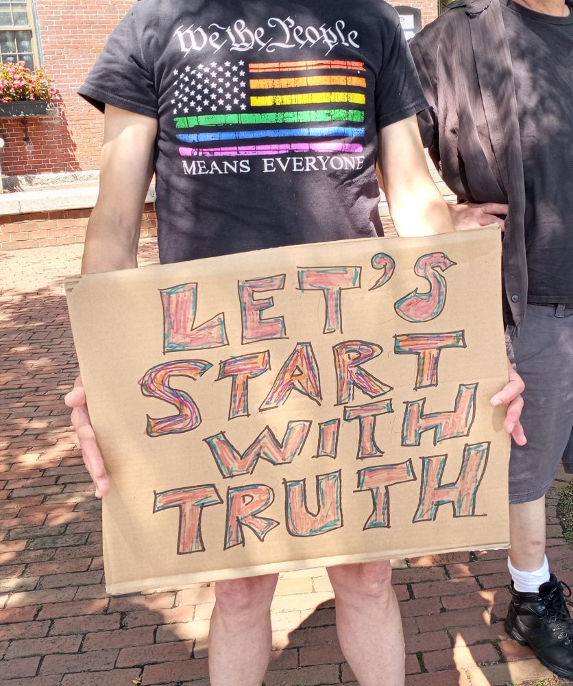 Image of today's Rage Against the Regime protest: a T shirt with the American flags stripes as rainbow, reading "We the People means everyone"