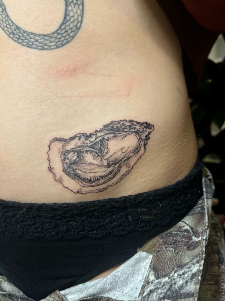 Close up of an open oyster tattoo