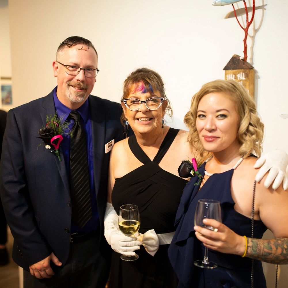 Three people with big smiles on their faces posing for a picture at the Archival Gallery 40th Anniversary celebratory event.