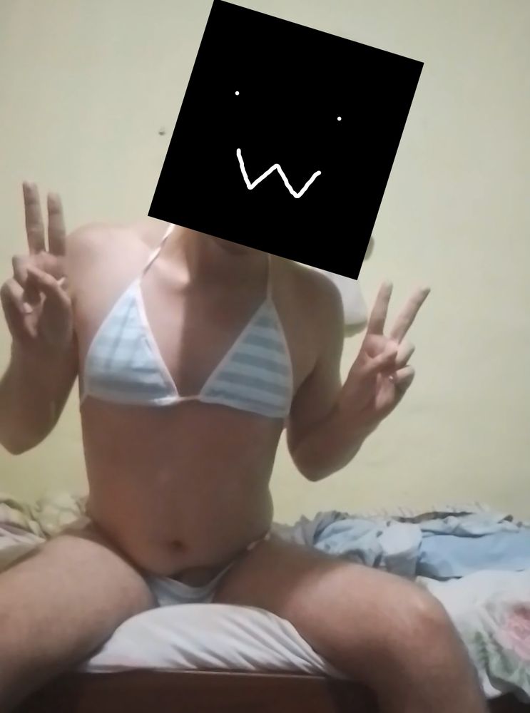 lily (face censored) giving the camera two peace signs while wearing a blue and white striped bra and panties