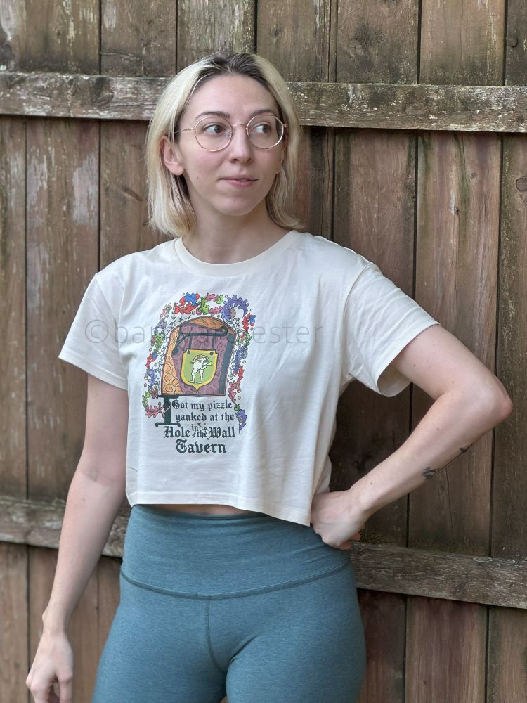 A model wearing the Hole in the Wall Tavern crop top.