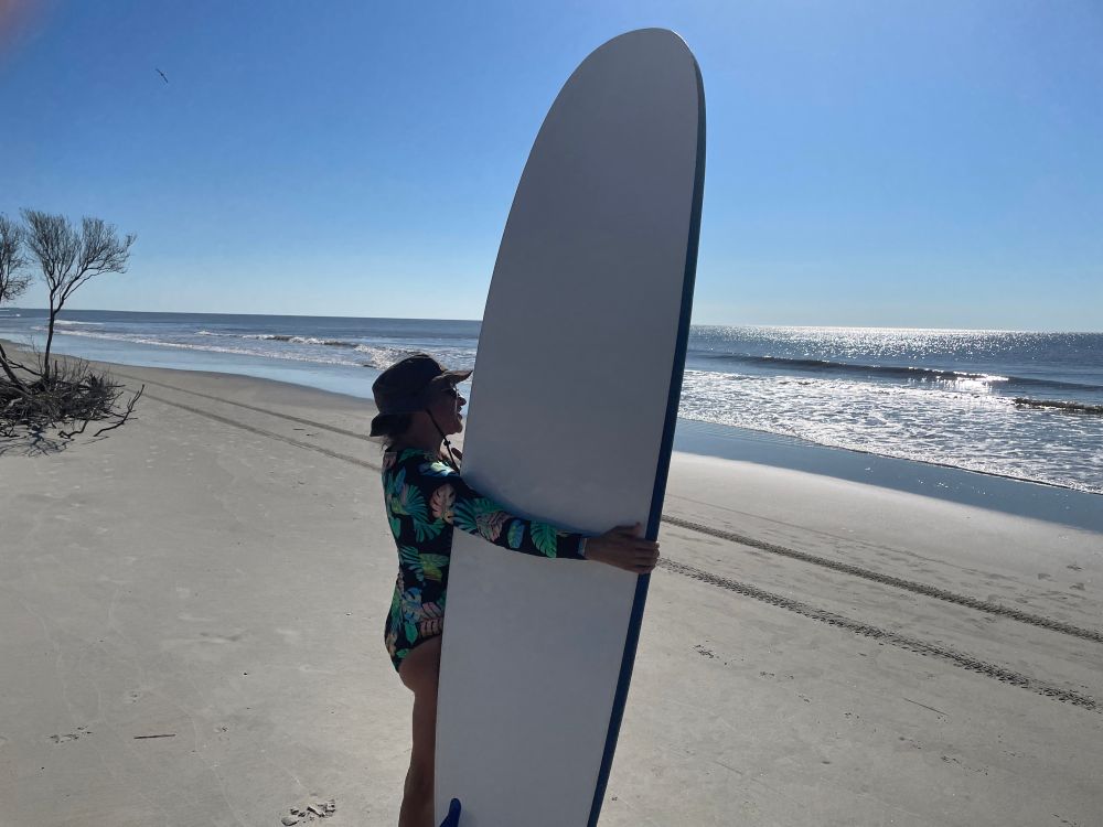 Standing on the sand with my surfboard.