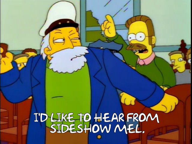 Flanders from The Simpsons saying “I’d like to hear from Sideshow Mel!”