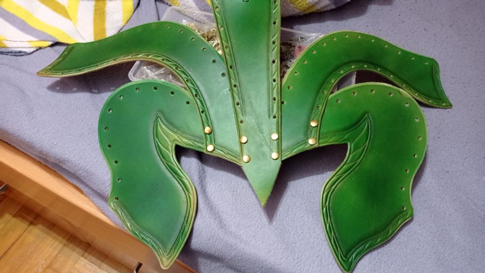 All 5 different parts of the elven leather helm dyed in green, with only the frontal part riveting all the parts together