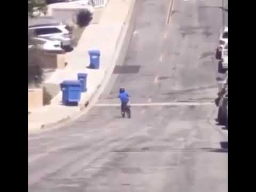 kid on bicycle crashes into garbage bins in sync with music