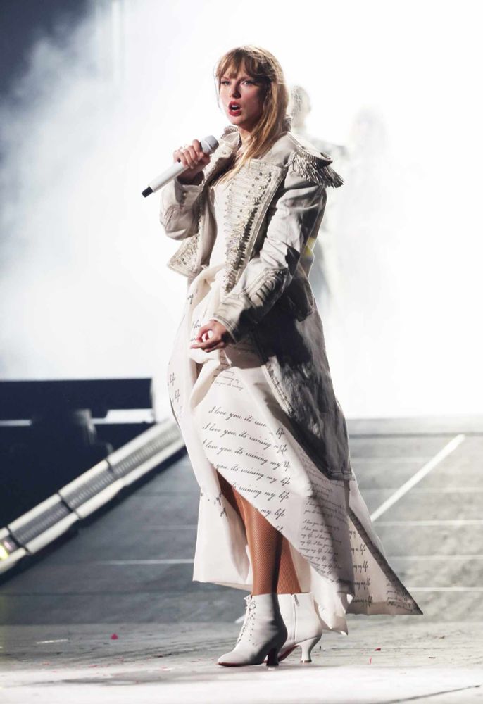 taylor swift wearing the ttpd dress with the tsmwel jacket at the eras tour