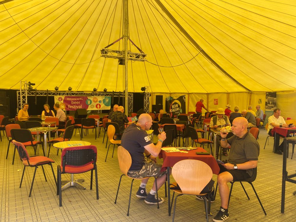 People drinking inside a tent