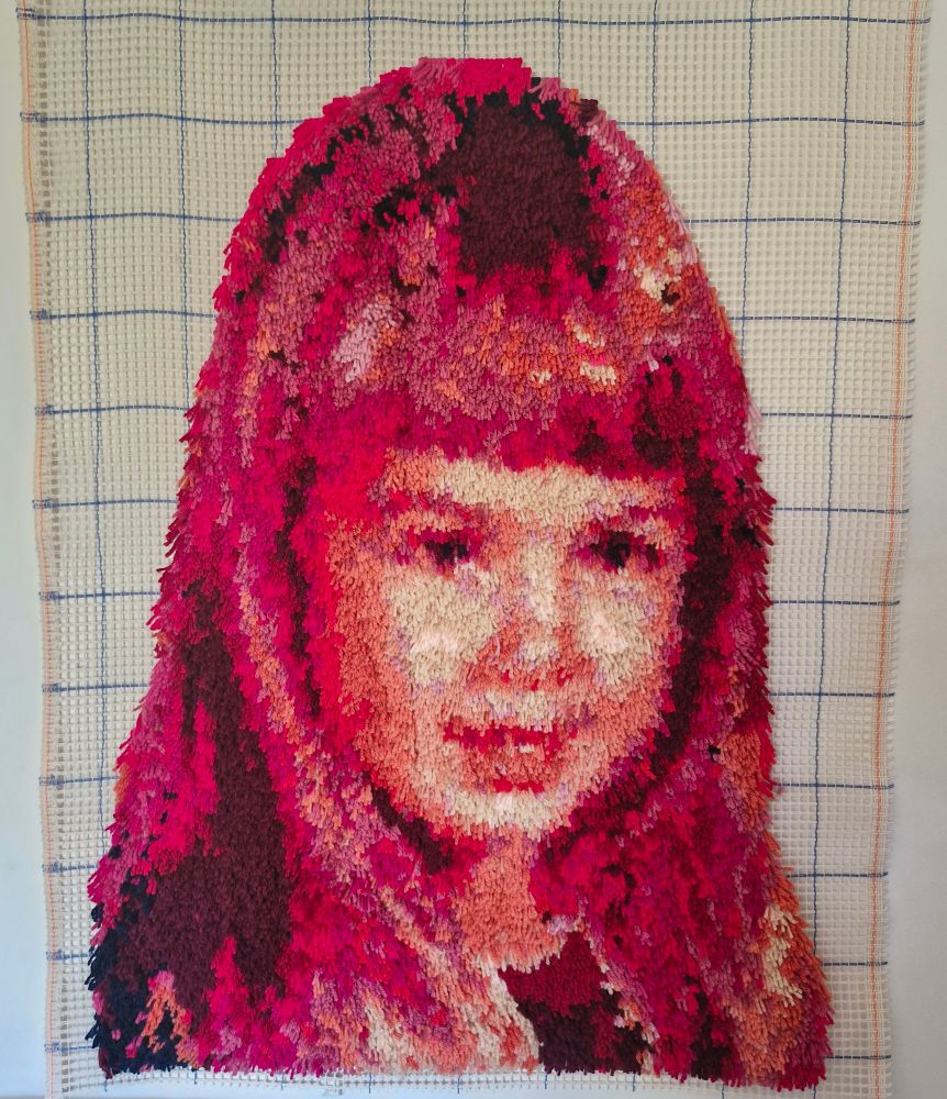 Art piece #1. The head of a small child in reds and pinks.