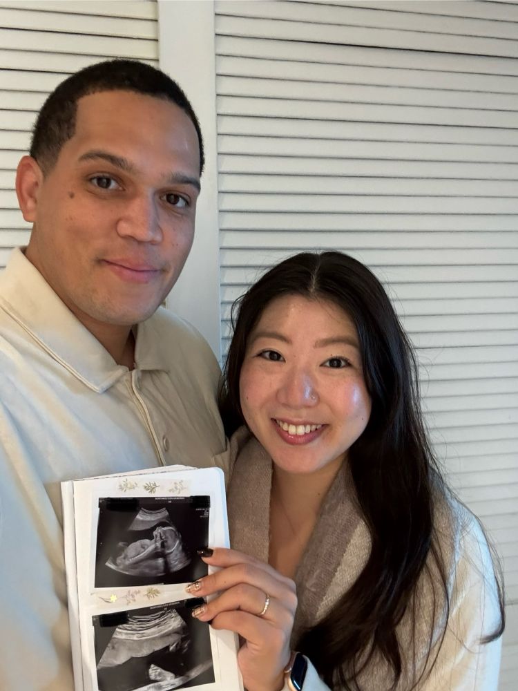 My wife and I holding a sonogram of our, hopefully, soon to be child. 