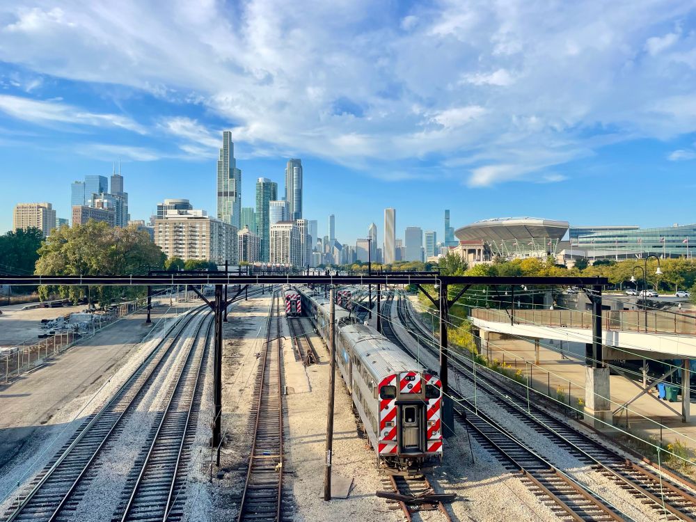 A Metra train near Soldier Field with the Chicago skyline in the background (view looking north from the 18th St bridge)
