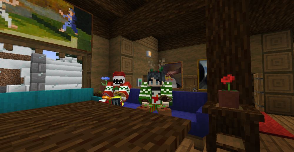 A screenshot from a modded Minecraft server of a well-lit cabin interior. The perspective is set from the living room, where blue and cyan couches sit around a spruce wood coffee table, are flanked by spruce wood end tables decorated with potted poppies and cornflowers, and a peeking corner of a red carpet pokes out from behind the couch. A snowy morning is seen outside through the window and many paintings hang on the walls around the space. Two players in red and green festive-themed pajama wear and ugly sweaters sit on the blue couch, the player dressed in red enjoying maple syrup pancakes with a strawberry smoothie while the player dressed in green enjoys a piece of Vegemite on toast with a cup of café con leche.