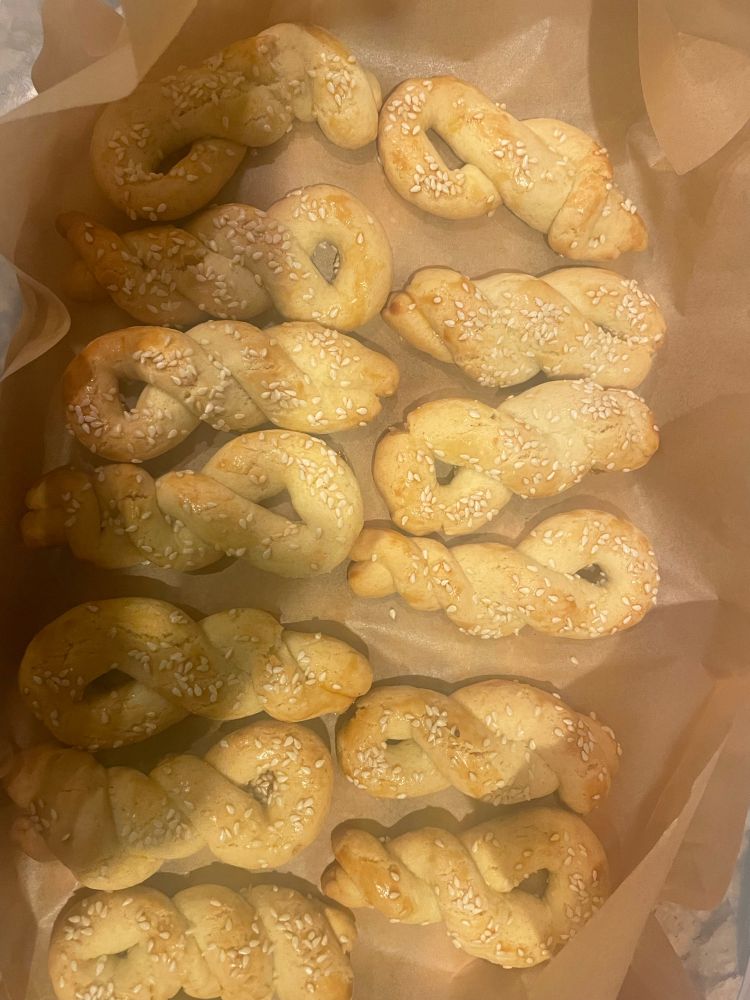 Golden brown braided cooked with sesame seeds on parchment paper 