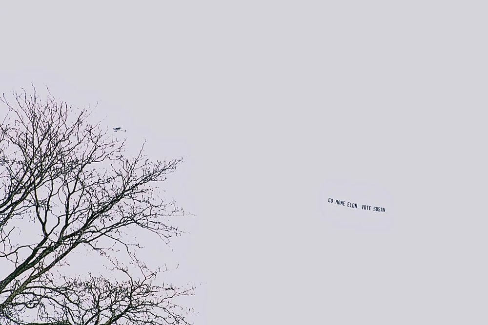 Airplane sky banner message states "Go Home Elon, Vote Susan"  Supreme Court race in Wisconsin. 