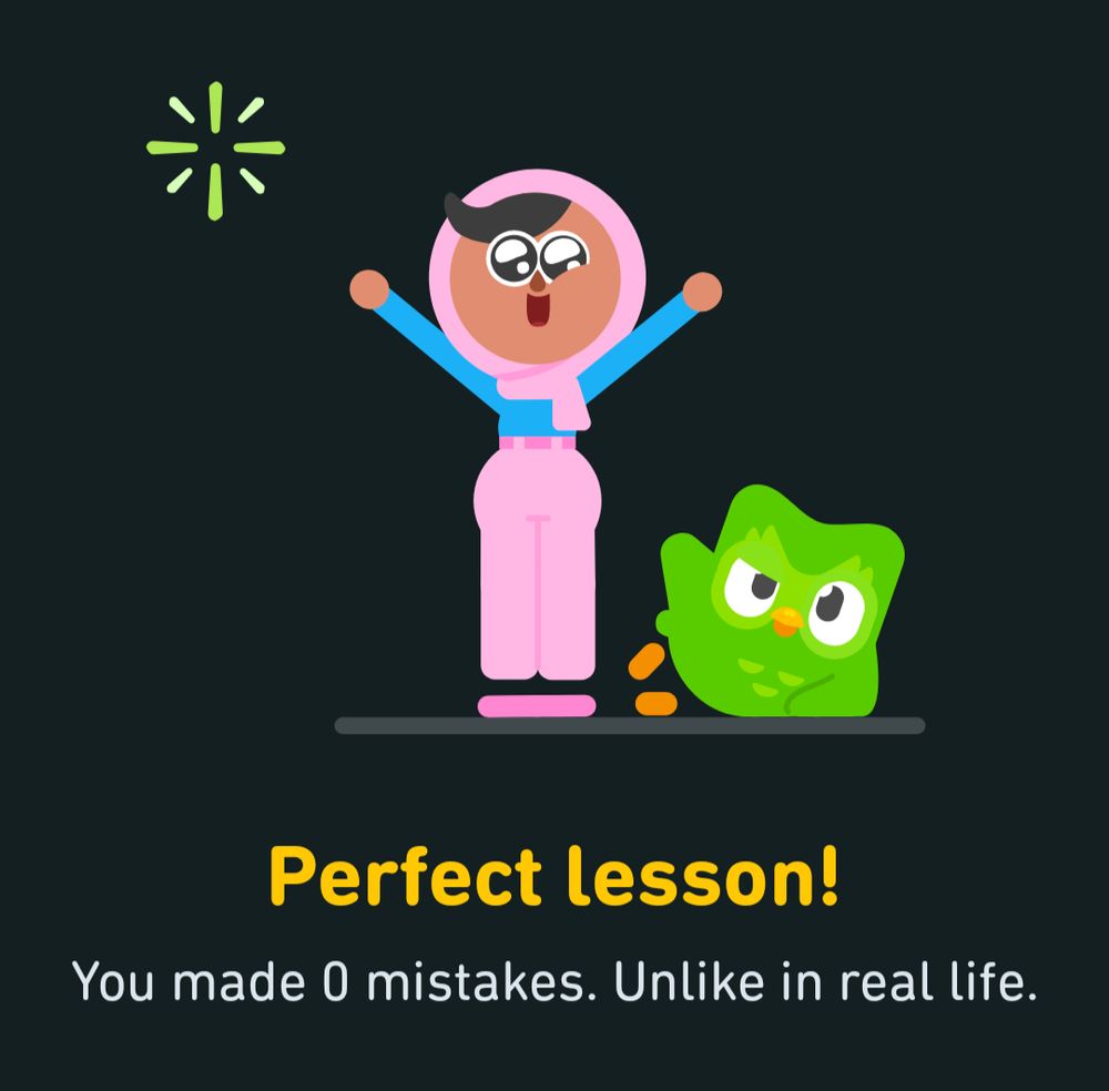 A cartoon image of a young girl celebrating with her arms in the air, with the green Duolingo owl laid on the ground next to her, leaning on its elbow.

Below, the text "Perfect lesson! You made 0 mistakes. Unlike in real life."